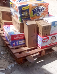 Carring food, water and basic needs items by a forklift.